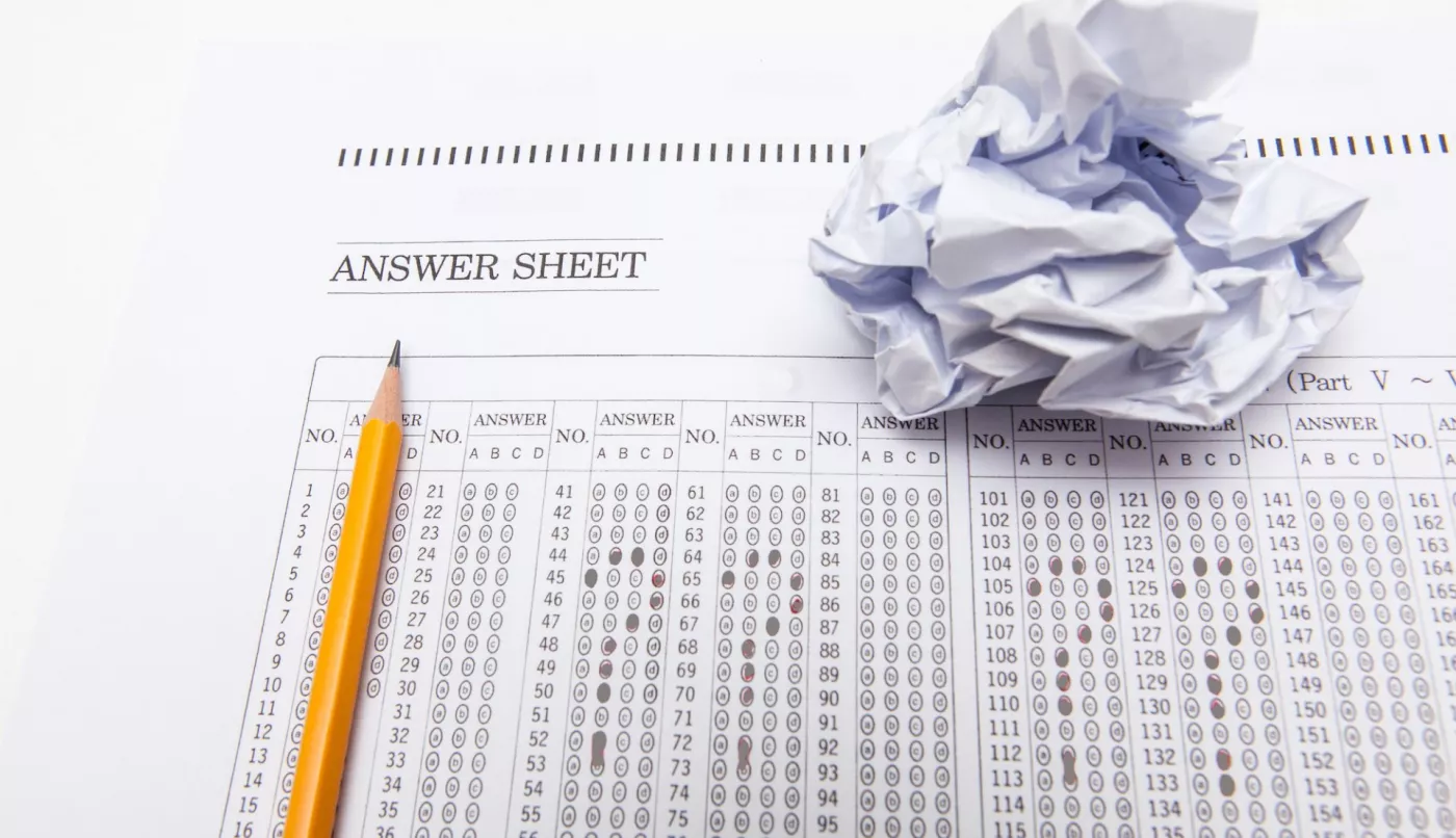 an image of a pencil on a traditional bubble-fill-in standardized test with the bubbles filled in to show question marks.