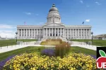 Utah Capitol Building on sunny day with yellow flowers. 
