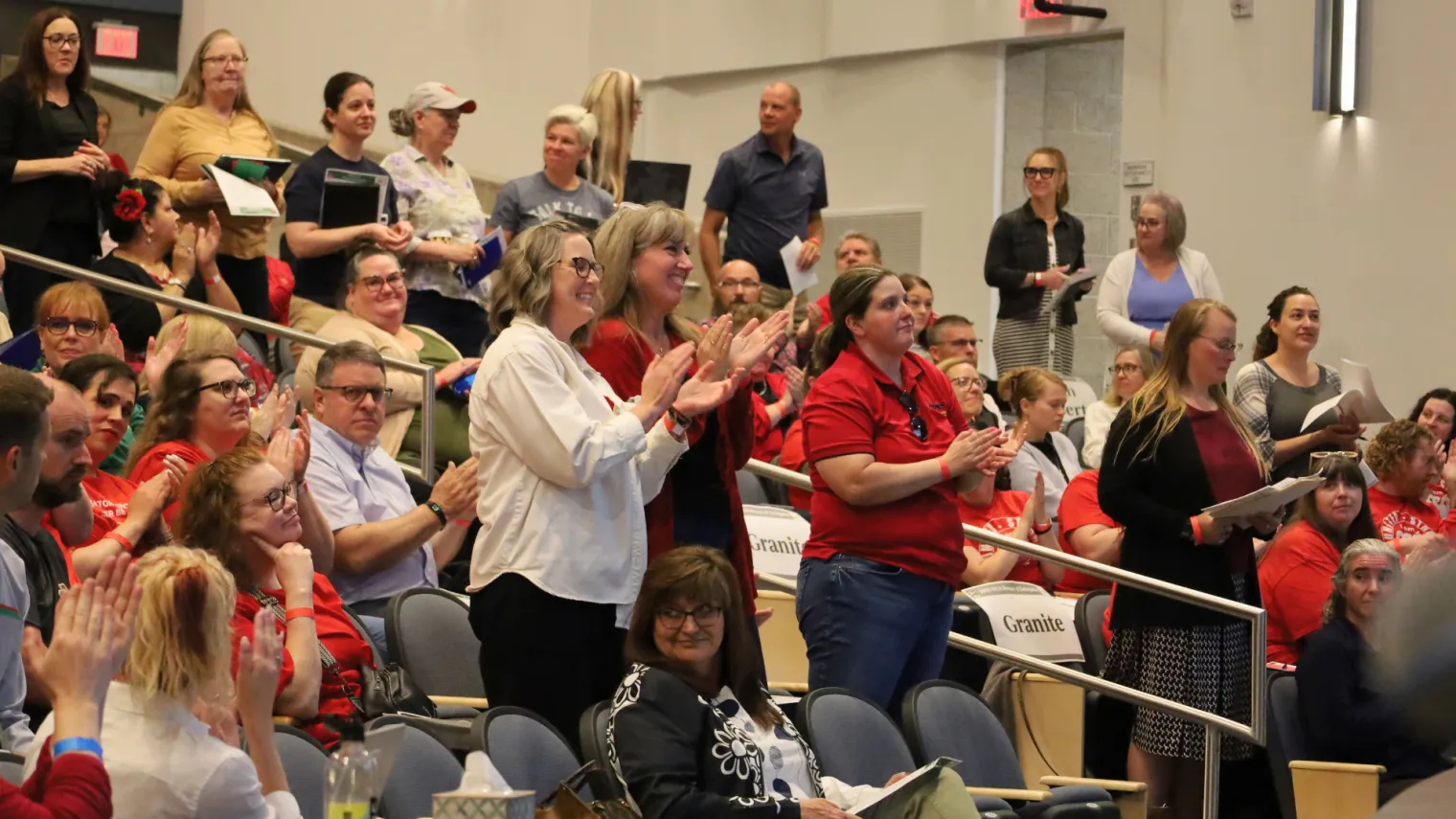 Women give standing ovation.