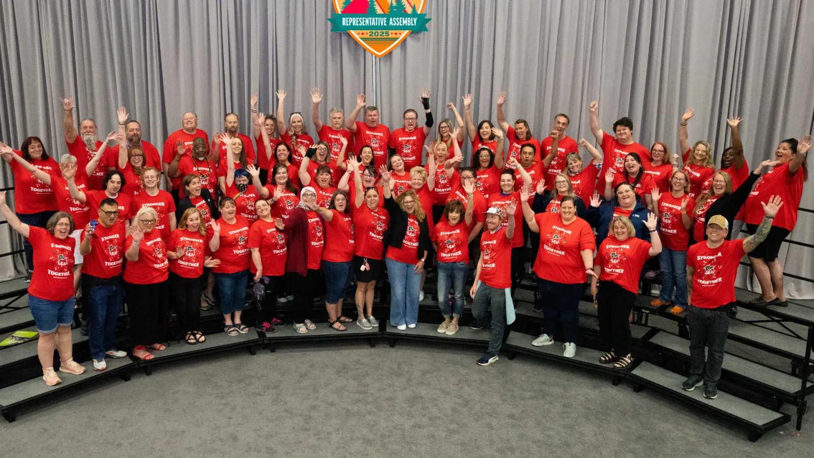 Group of educators wearing red smile at the camera.