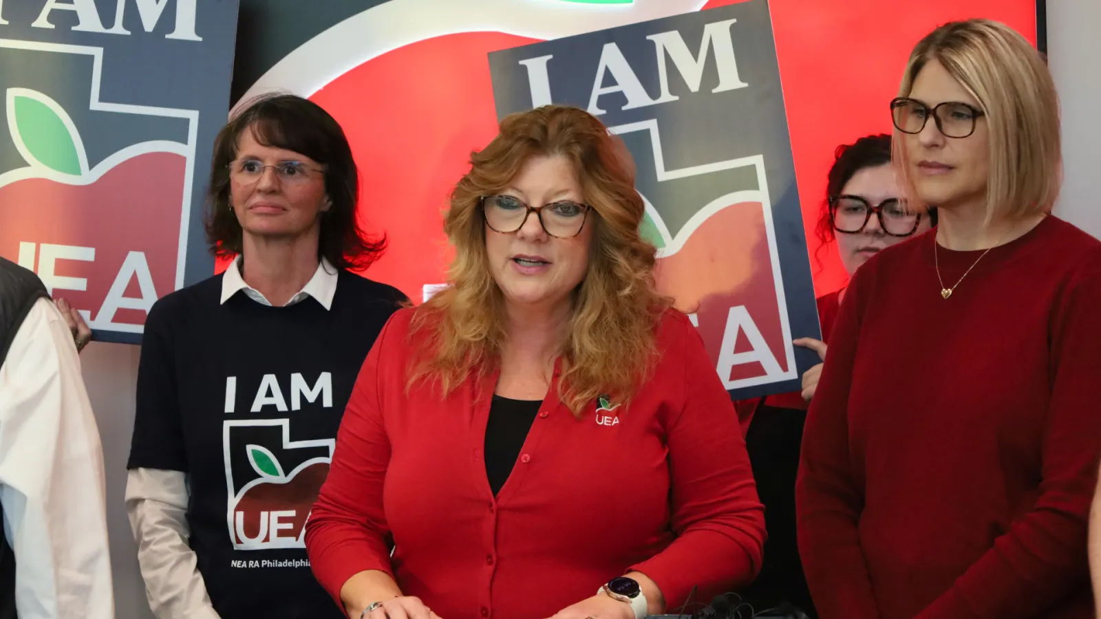 Renee Pinkney with educators at podium