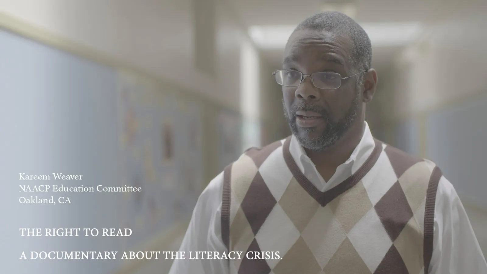Black man in school hallway.