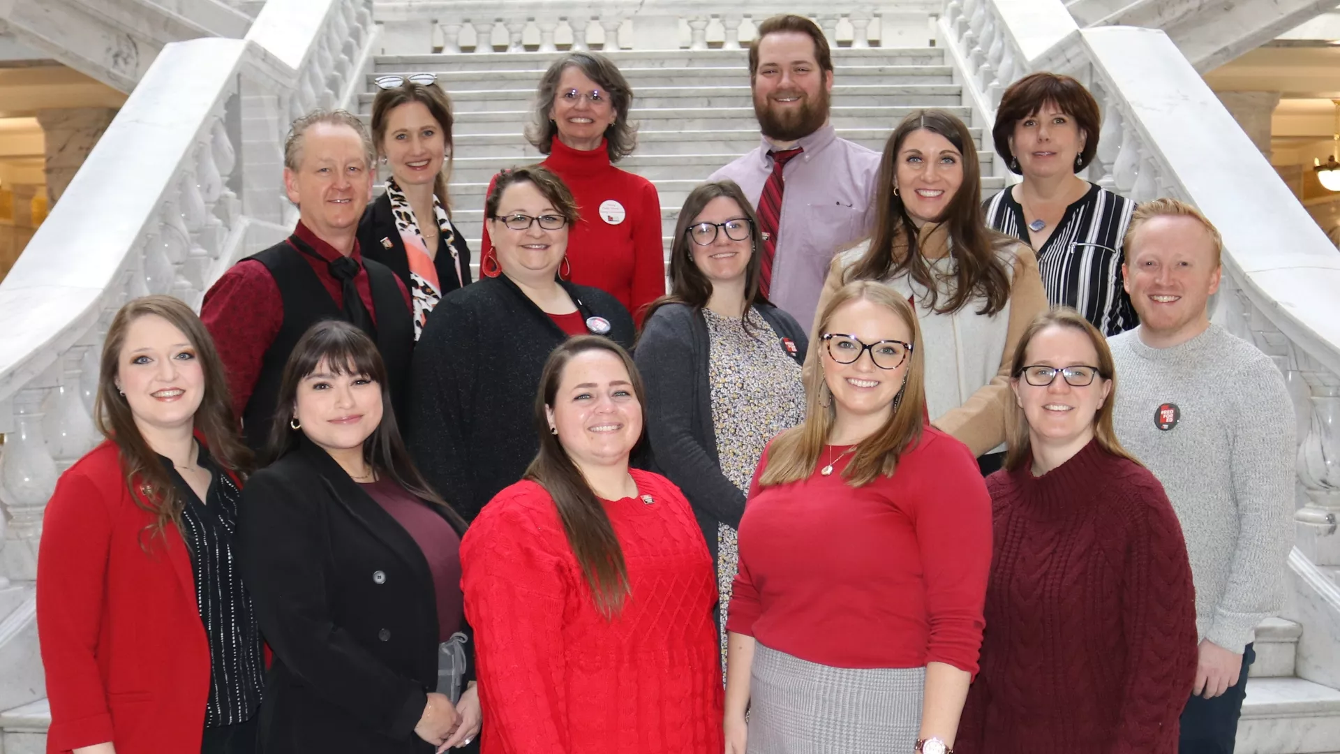 A group of teachers standing on marble steps at the Utah Capitol.