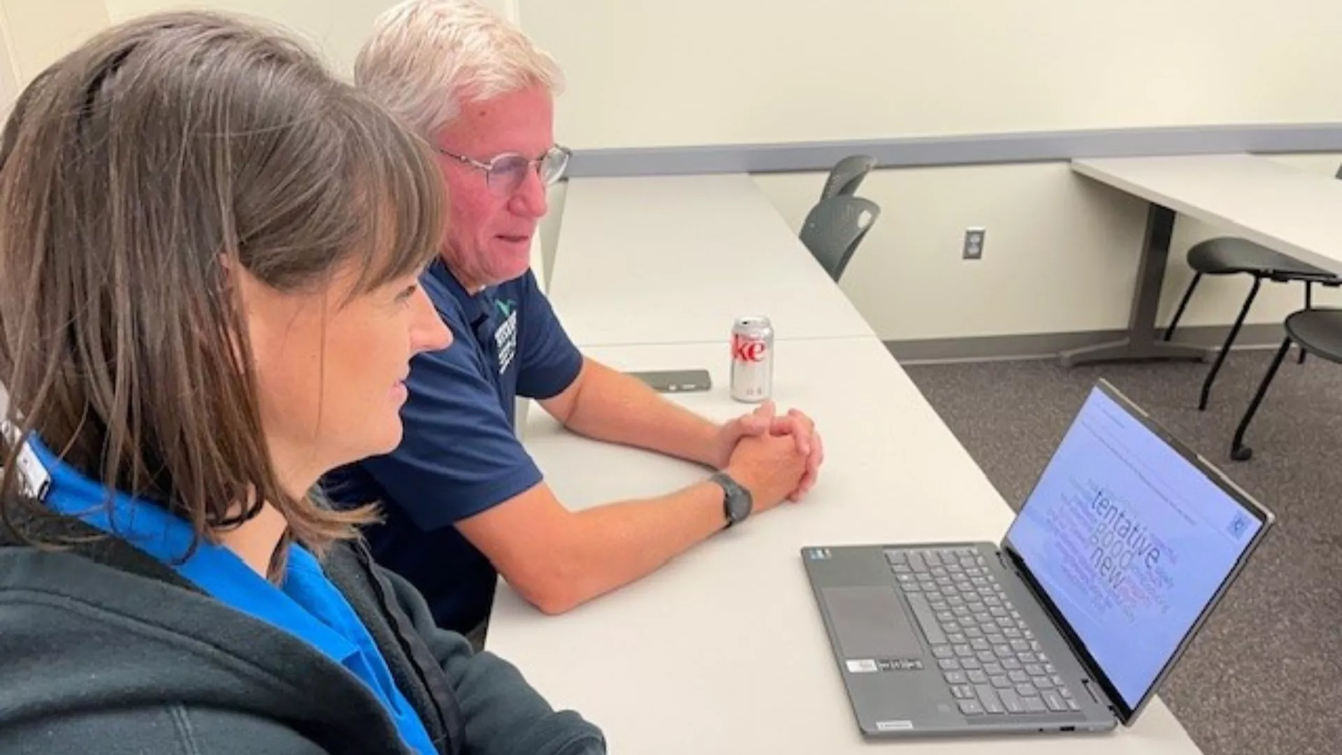 Man and woman look at computer screen during Bargaining Summit 2023