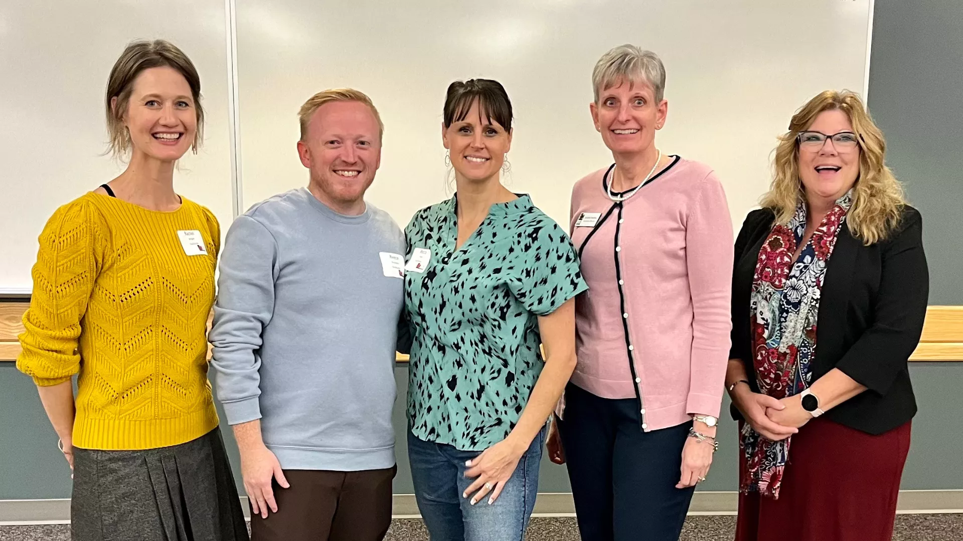 Five members of Utah Education Association smiling in a conference room.