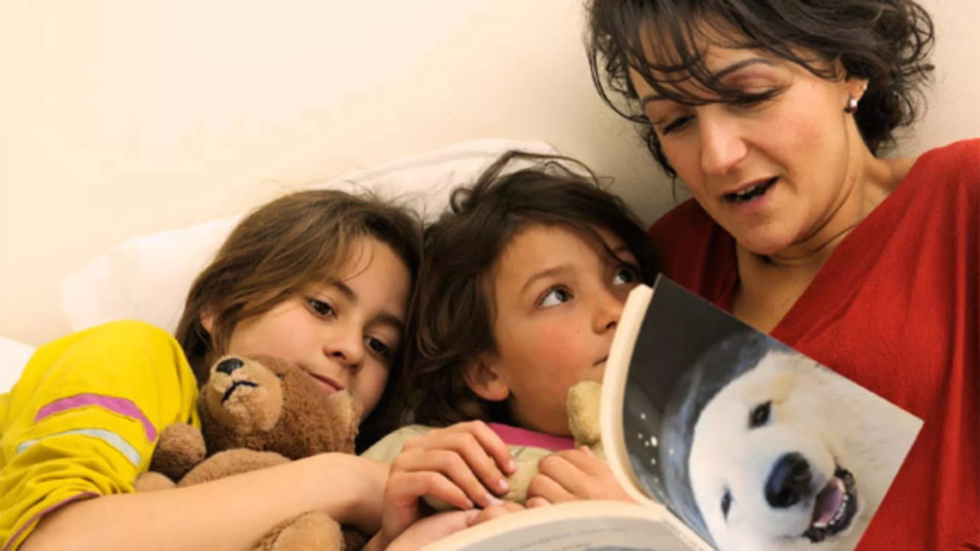 A parent reading to her children