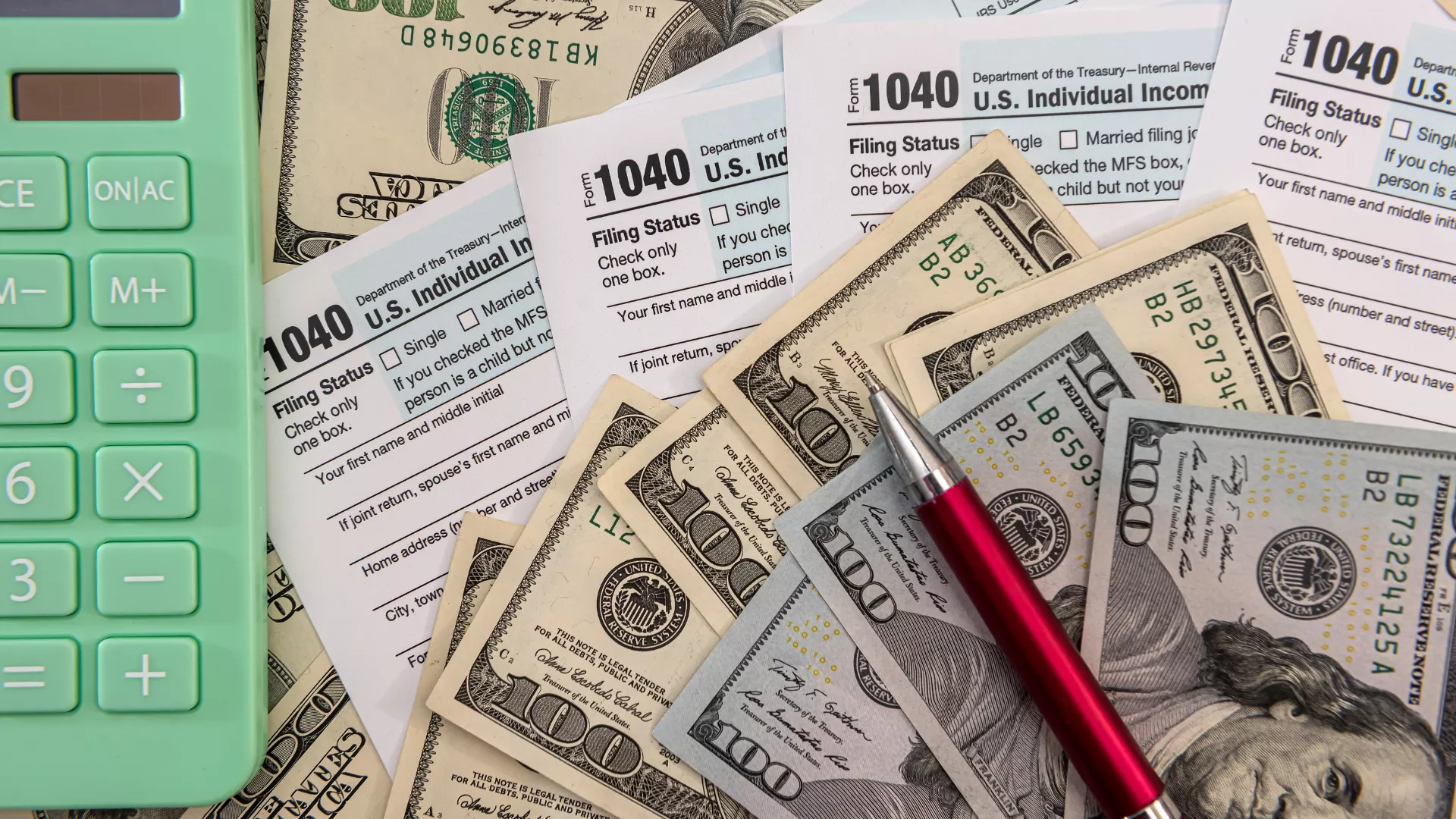 Picture of $100 bills, 1040 tax documents, a green calculator and a pen.