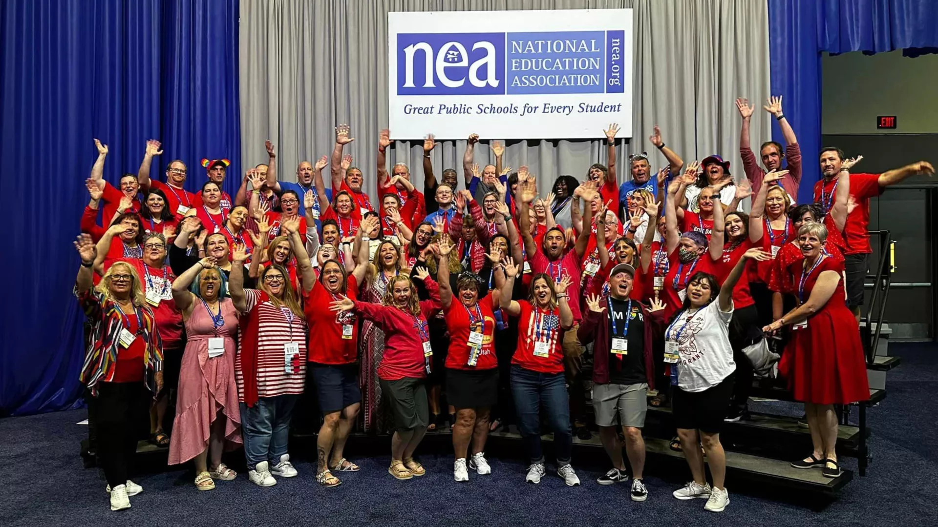 UEA NEA RA delegates dressed in red pose for a fun, silly-pose picture at the 2023 NEA RA.