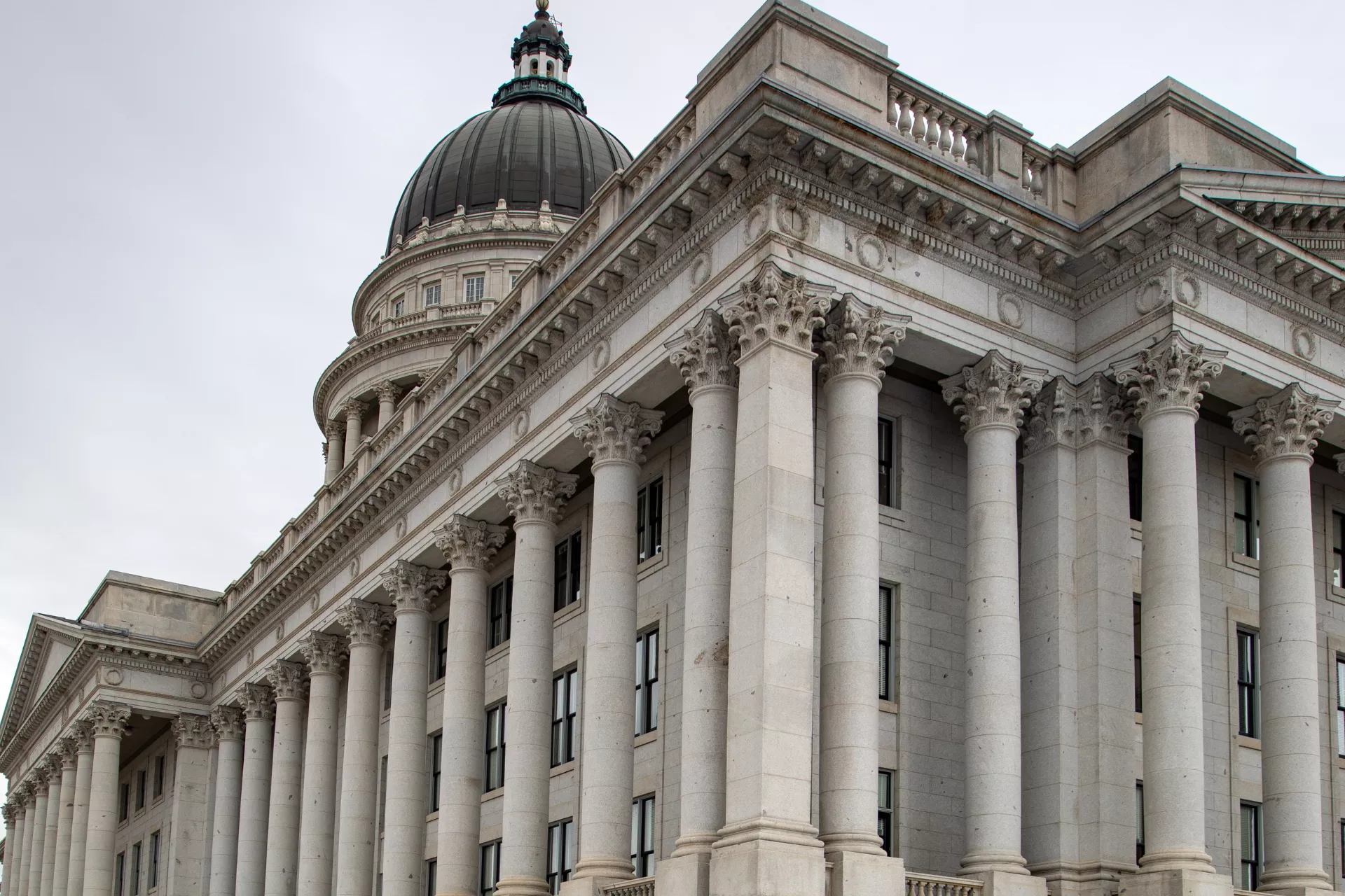 Exterior of Utah State Capitol on overcast day.