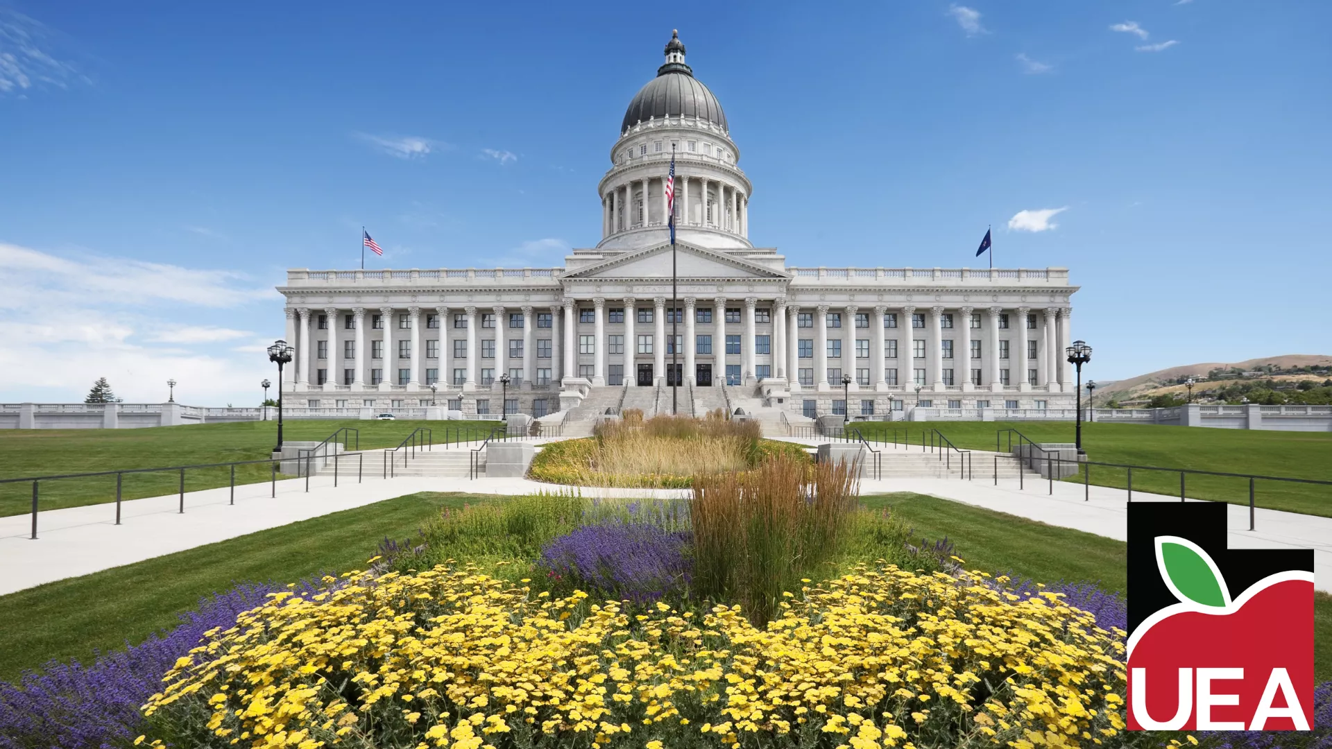 Utah Capitol Building on sunny day with yellow flowers.