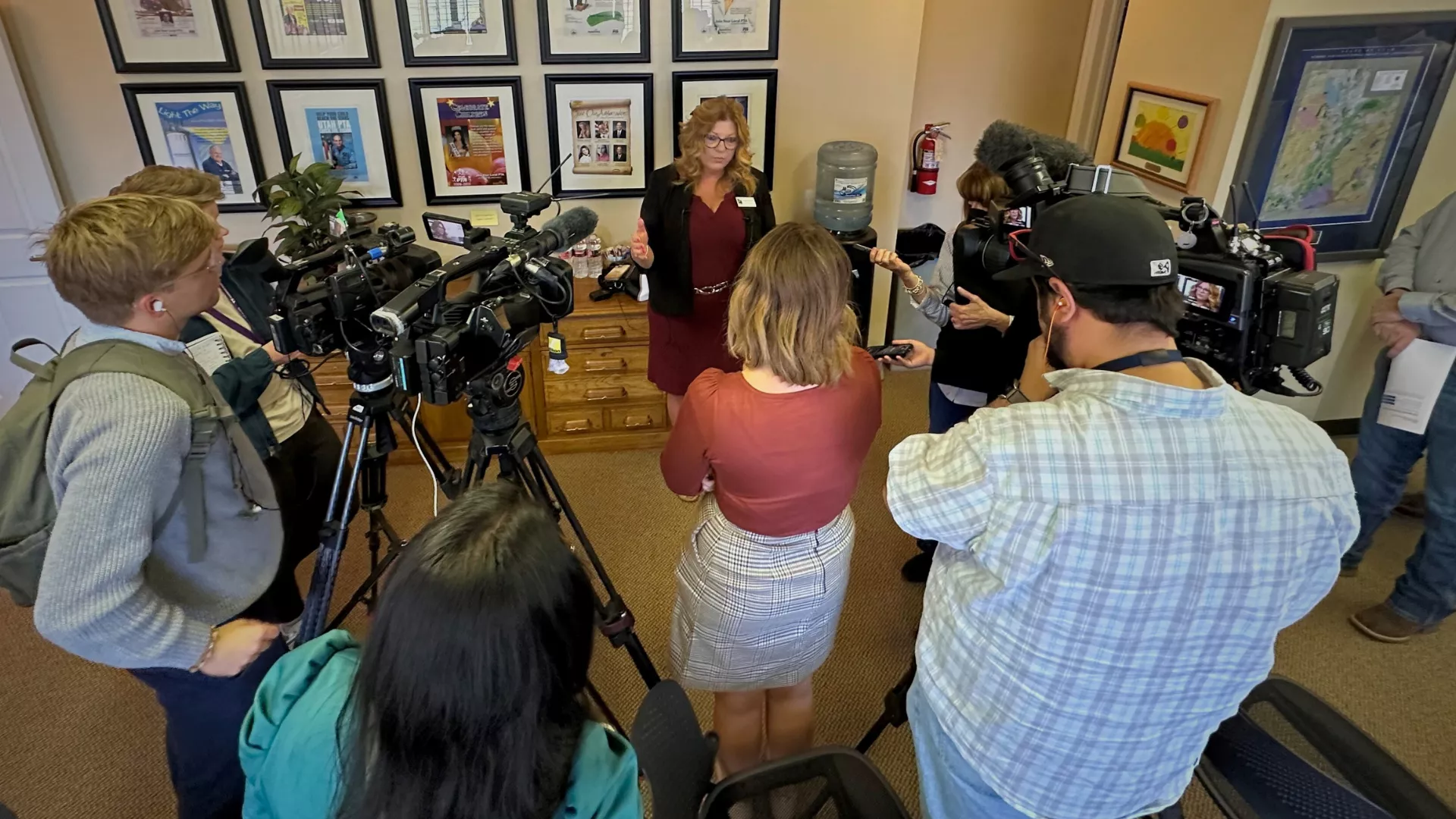 President PInkney stands in front of reporters answering questions. 