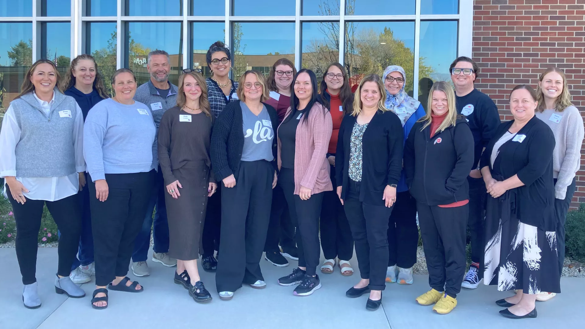 Group of educators standing outside and smiling. 