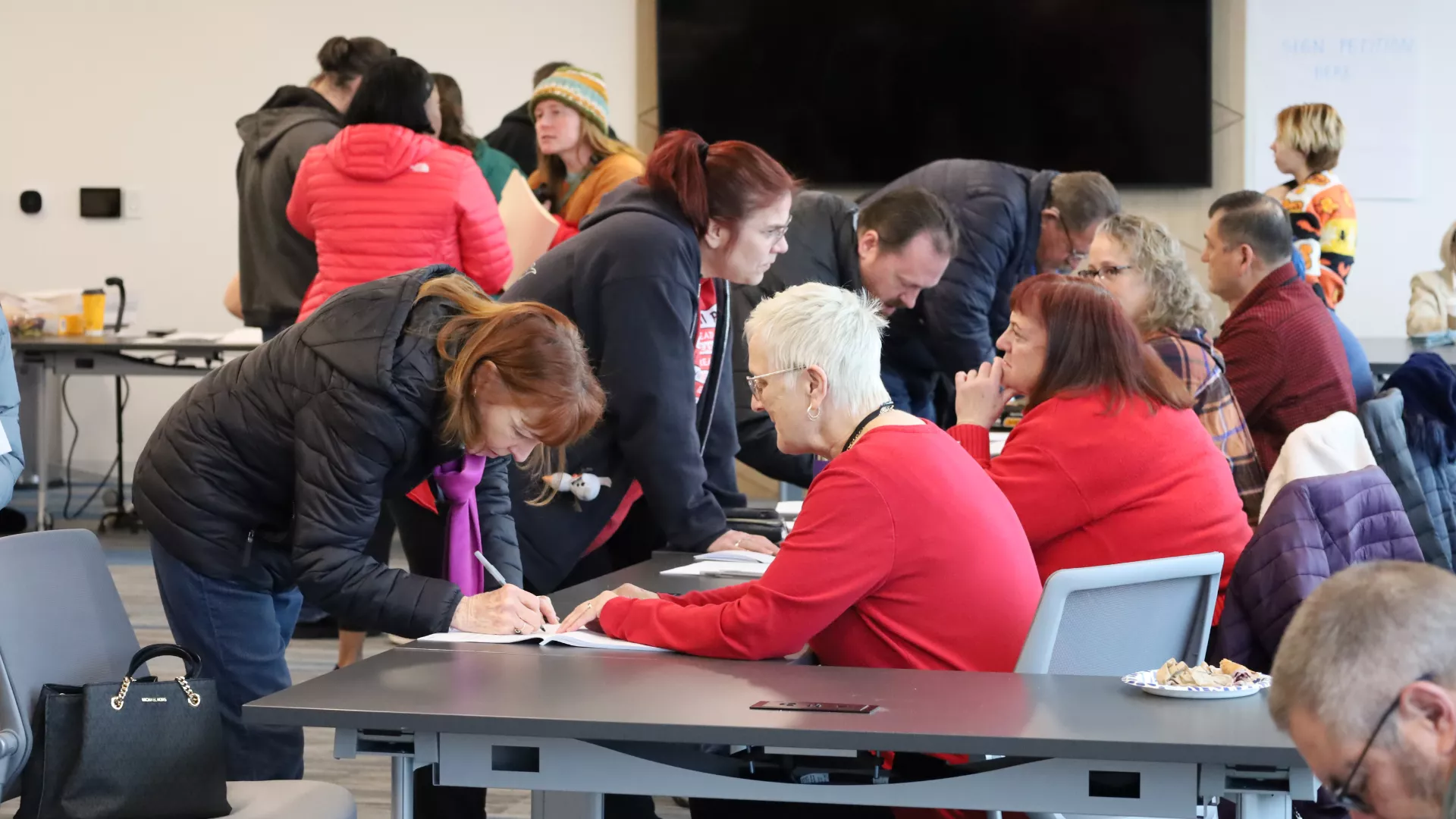 Line of people signing.
