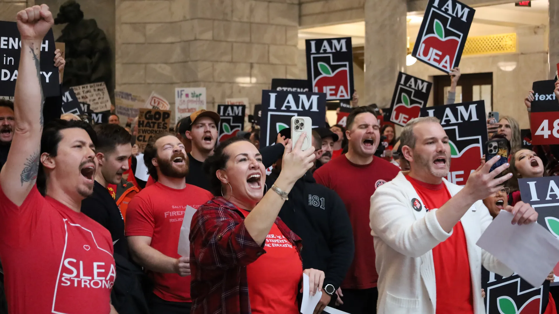 Group of people yell at rally. 
