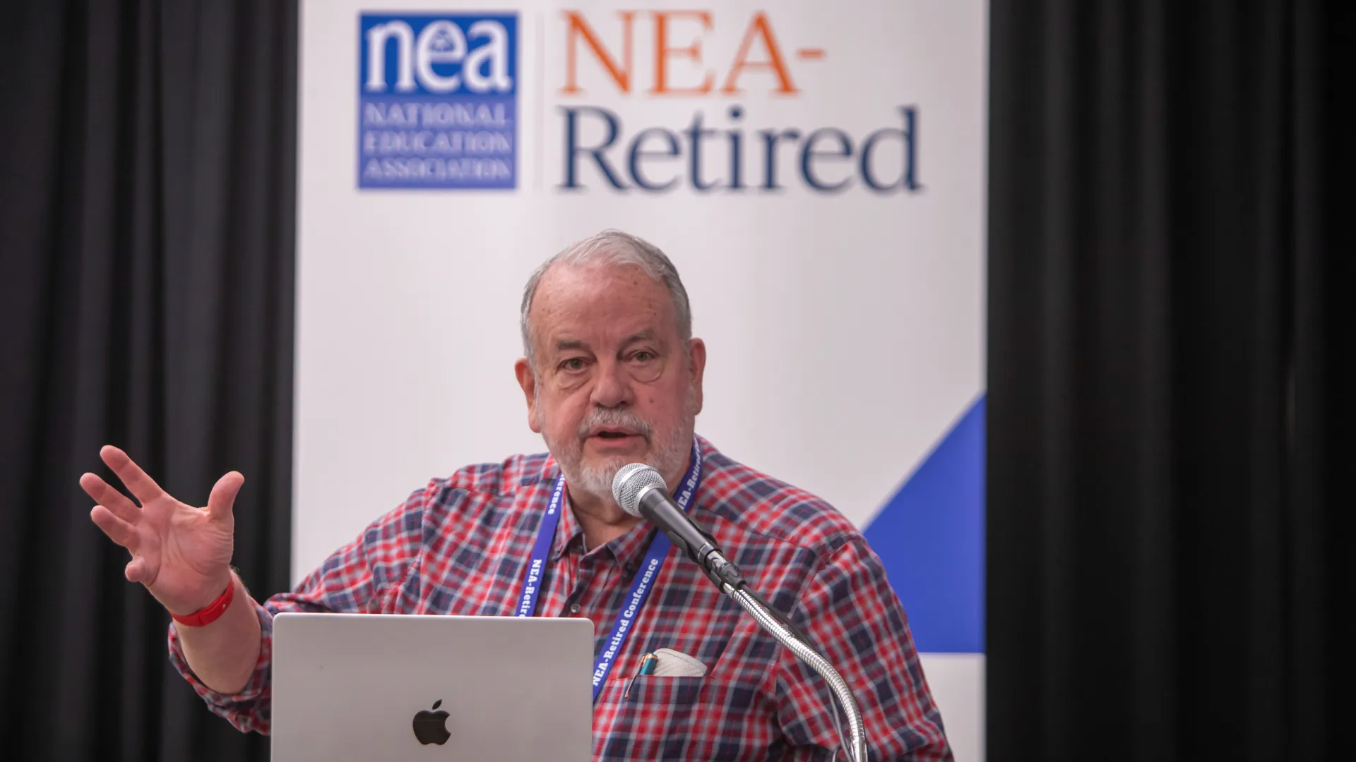 Man speaks at microphone.