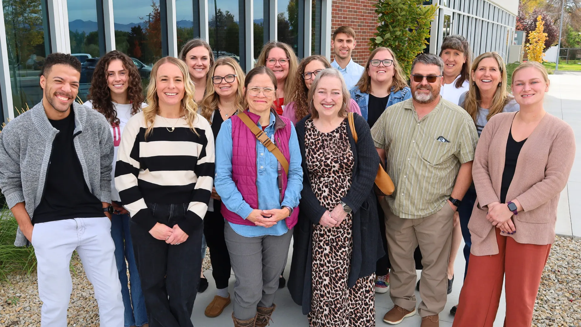 Group of people smiling outside.