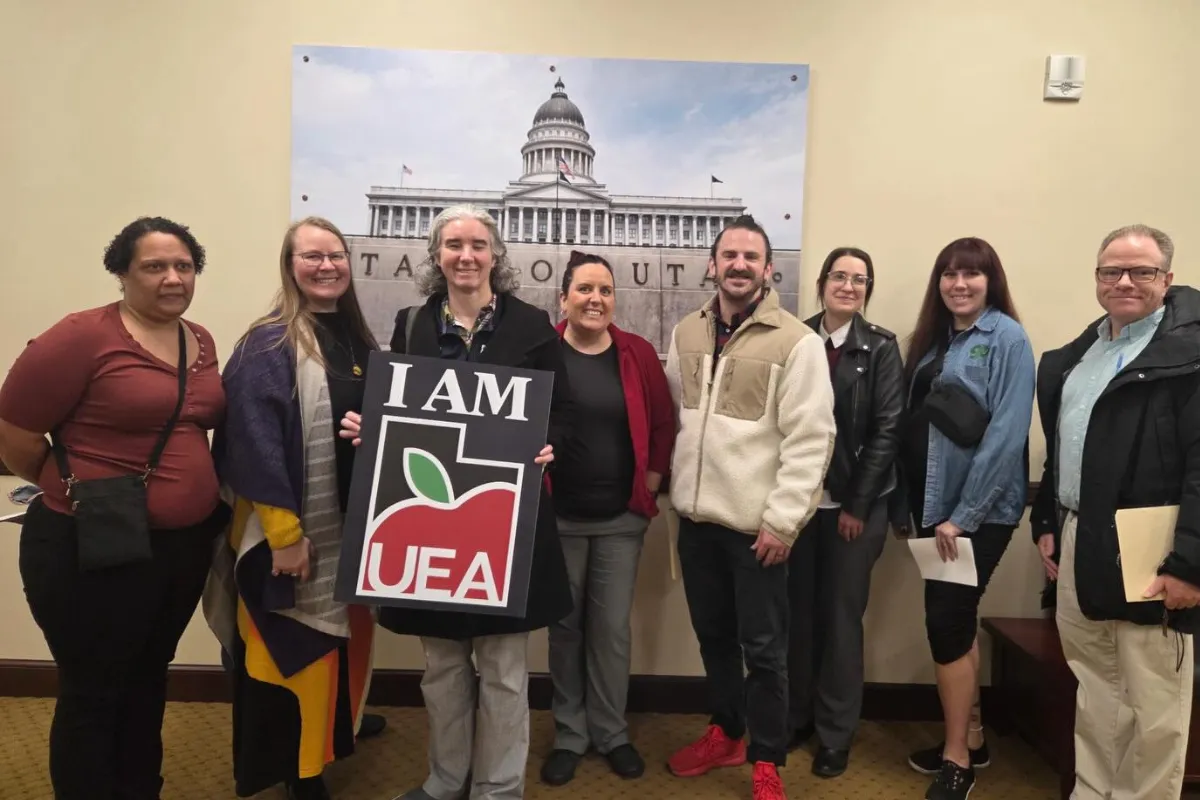 Group of people holding UEA sign