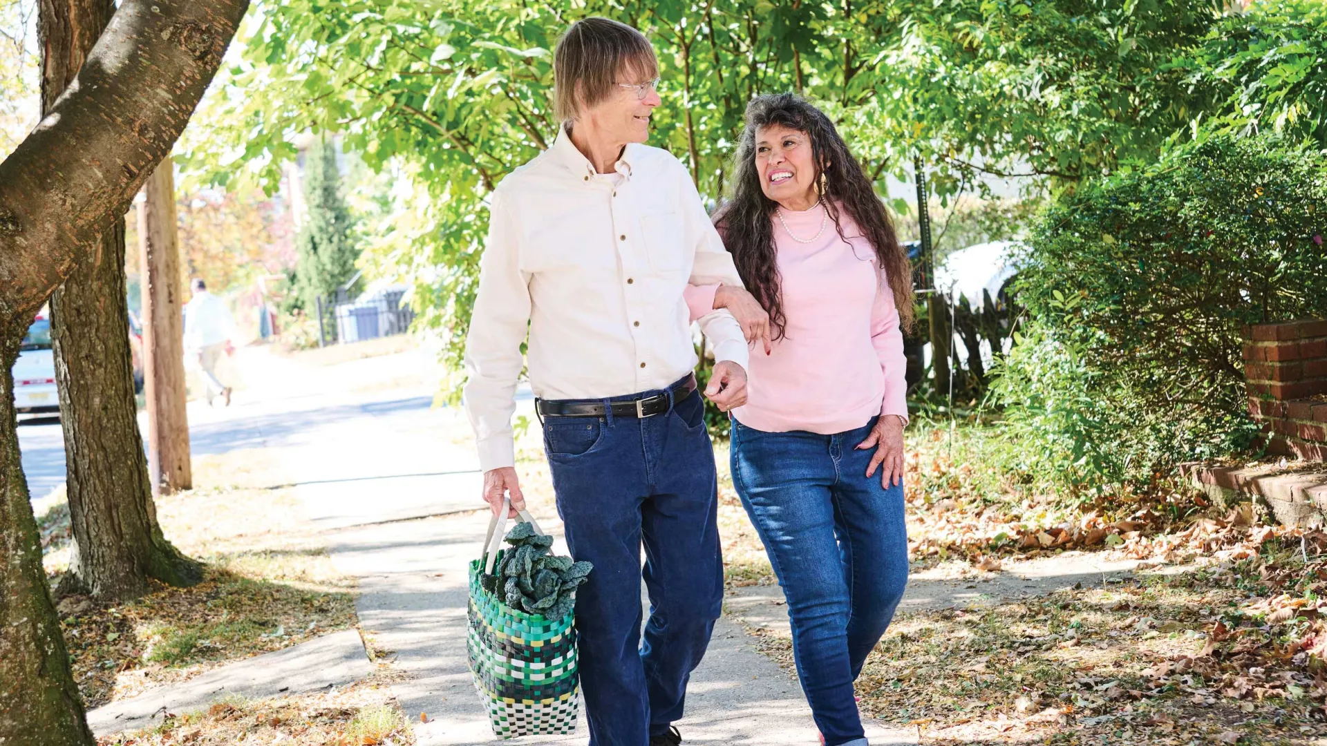 Former educator Susan Jaysnovitch and her husband, Andy, stroll home from the farmer’s market, where they stocked up on fresh fruits and vegetables. 