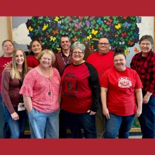 Group smiles wearing red