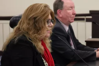 UEA President Renée Pinkney testifies at a microphone at the statehouse.