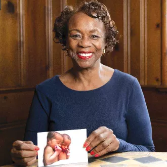 NEA-Retired member Valenta Ward-Gravely holding a picture of her twin grandsons Christian and Caiden.