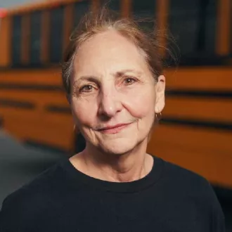 Christine 'Chris' Salamone in front of a school bus.