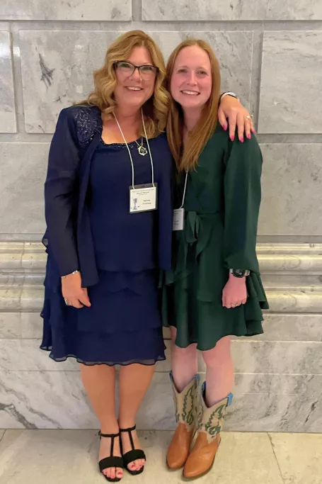 President Pinkney and Sayre Posey smile against a granite background.