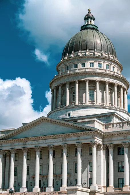 Picture of utah capitol with blue sky and clouds in foreground.