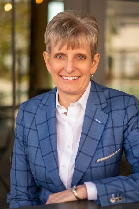 Picture of Jennifer in blue jacket and white shirt. 