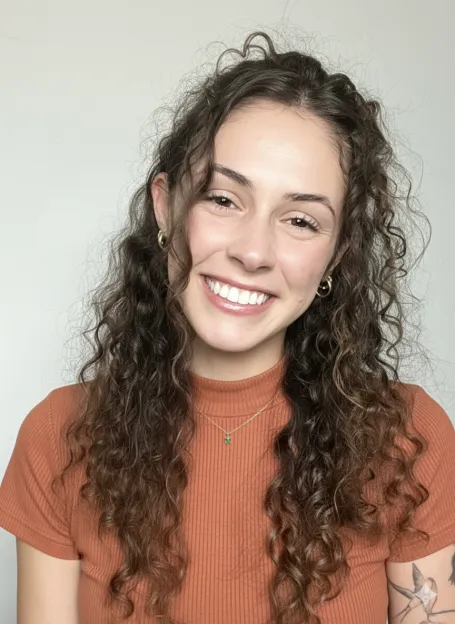 Picture of woman with curly brown hair smiling.