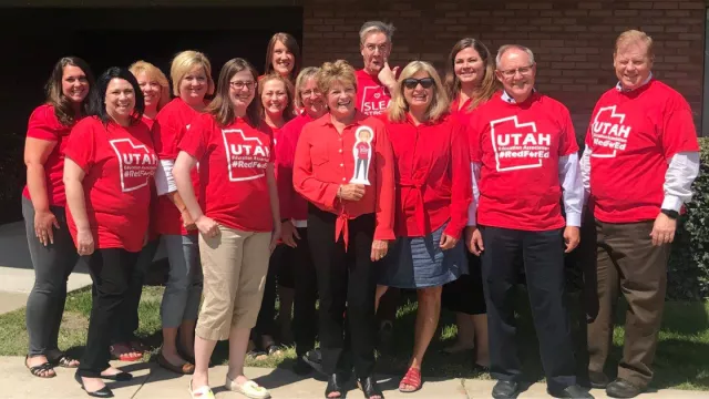 UEA staff pose for a picture wearing red for ed.