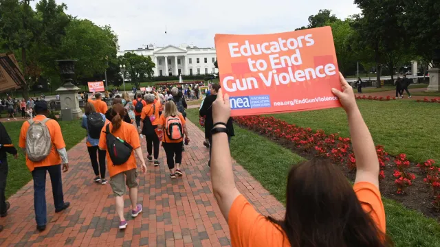 Educators in front of the White House with a sign that says "Educators to end gun violence"