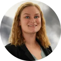 Woman smiling with brown hair.