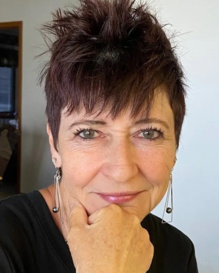 Woman smiling with brown hair.