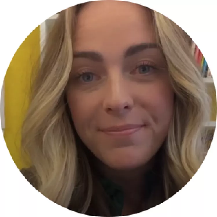 Blonde woman smiling.