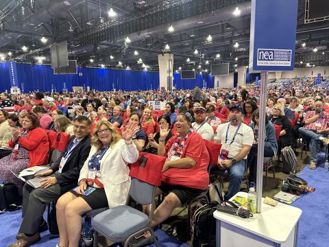 Large group of UEA delegates sitting on the convention floor.